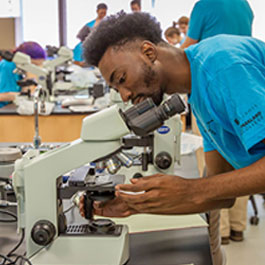 student at microscope